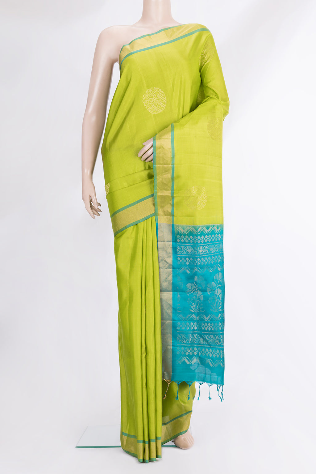 Pure Silk Parrot Green Soft Saree with Zari Butta on the body and Zari Border.  displayed on a mannequin