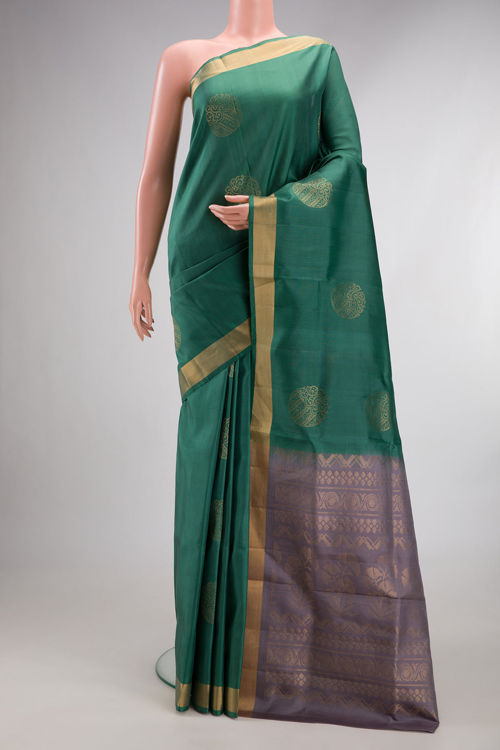 Pure Silk Green Soft Saree with Zari Butta on the body and Zari Border.  displayed on a mannequin