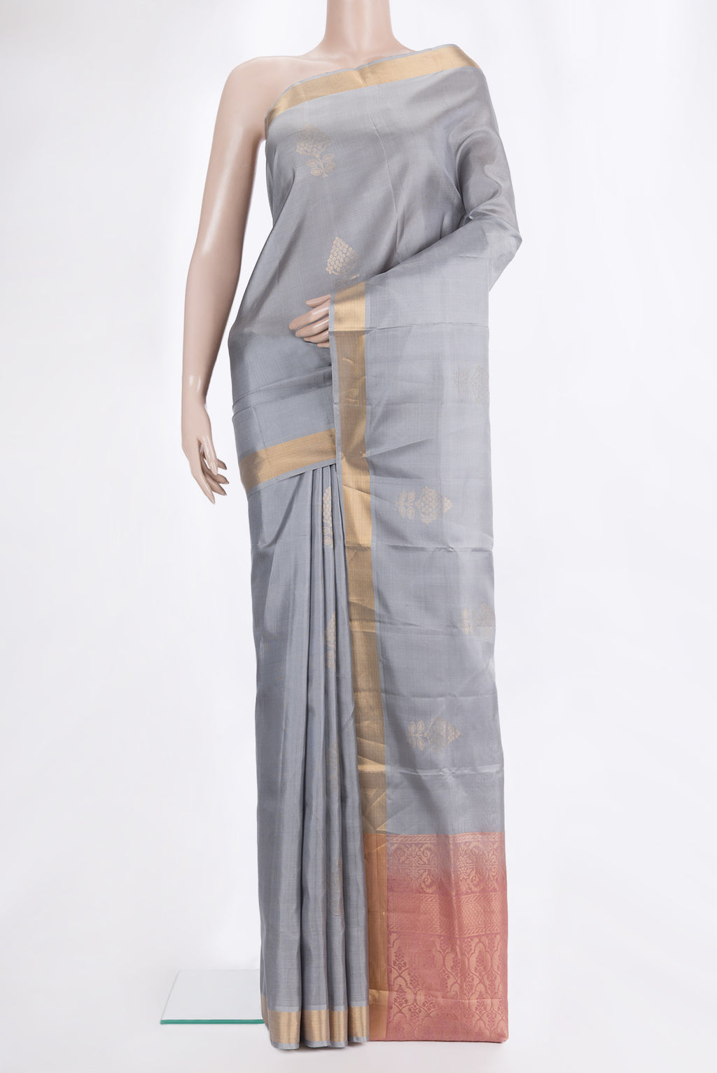 Pure Silk Grey Soft Saree with Zari Butta on the body and Zari Border.  displayed on a mannequin
