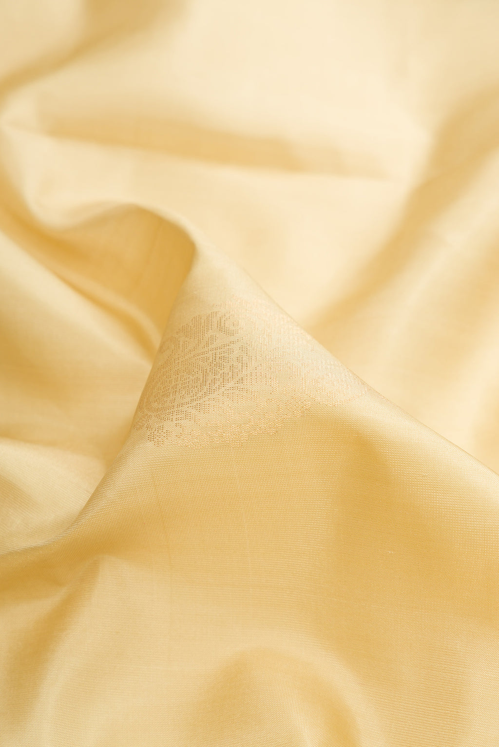 Close up of Pure Silk Sandal Soft Saree with Zari Butta on the body and Zari Border.  displaying folds