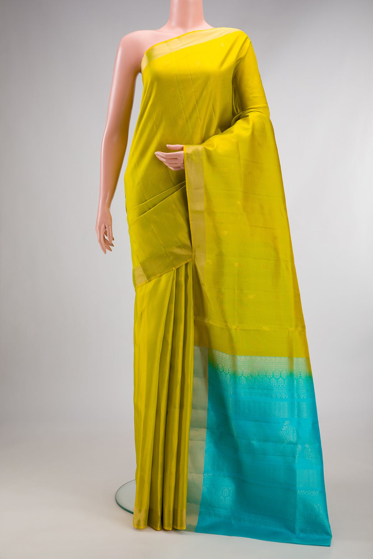 Pure Silk Lemon Yellow Soft Saree with Zari Butta on the body and Zari Border.  displayed on a mannequin