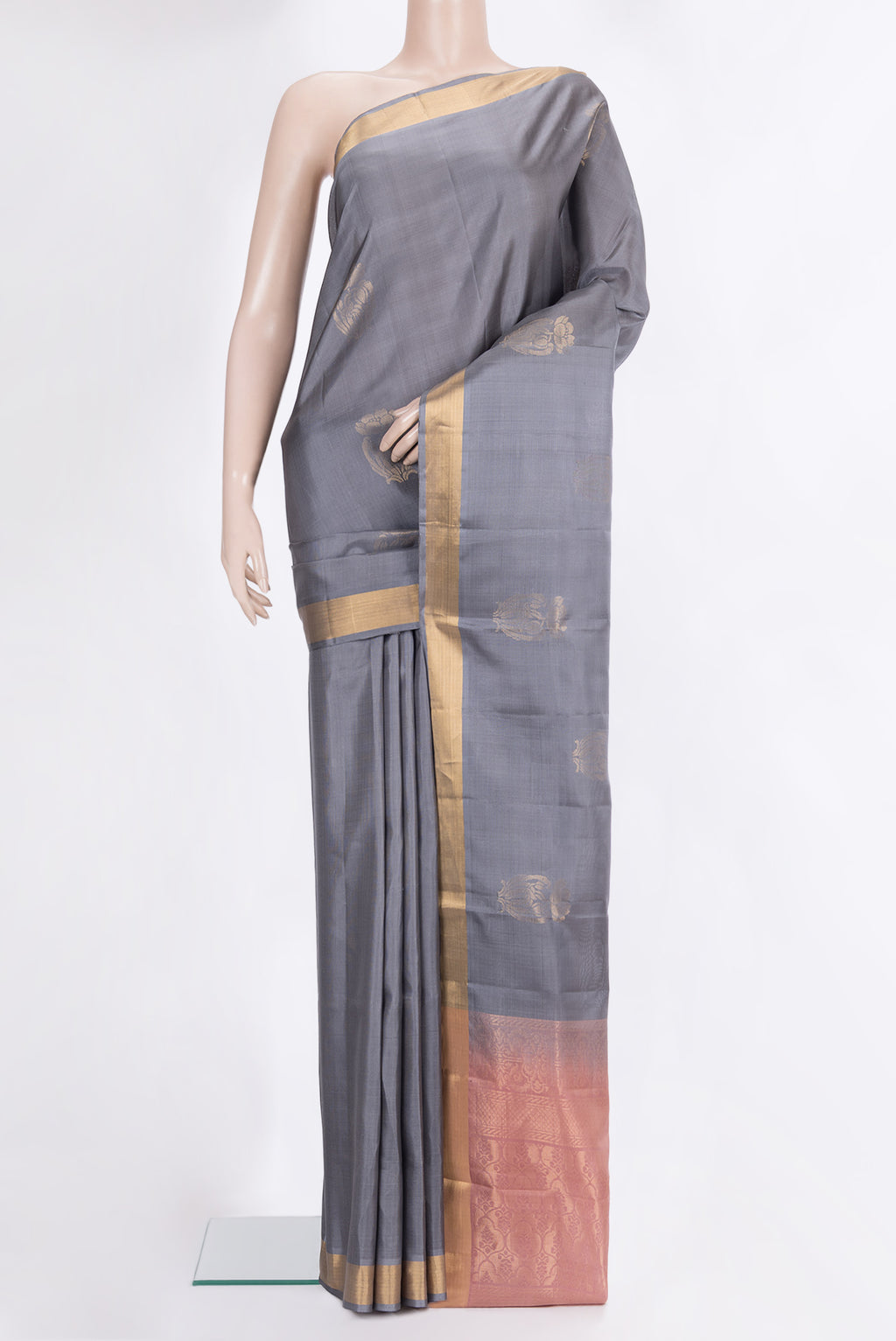 Pure Silk Grey Soft Saree with Zari Butta on the body and Zari Border.  displayed on a mannequin