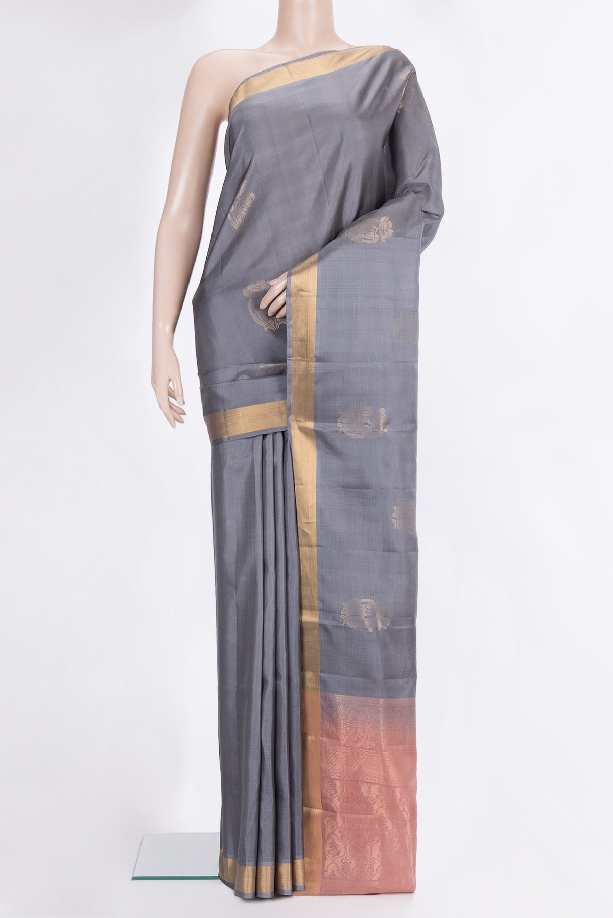Pure Silk Grey Soft Saree with Zari Butta on the body and Zari Border.  displayed on a mannequin