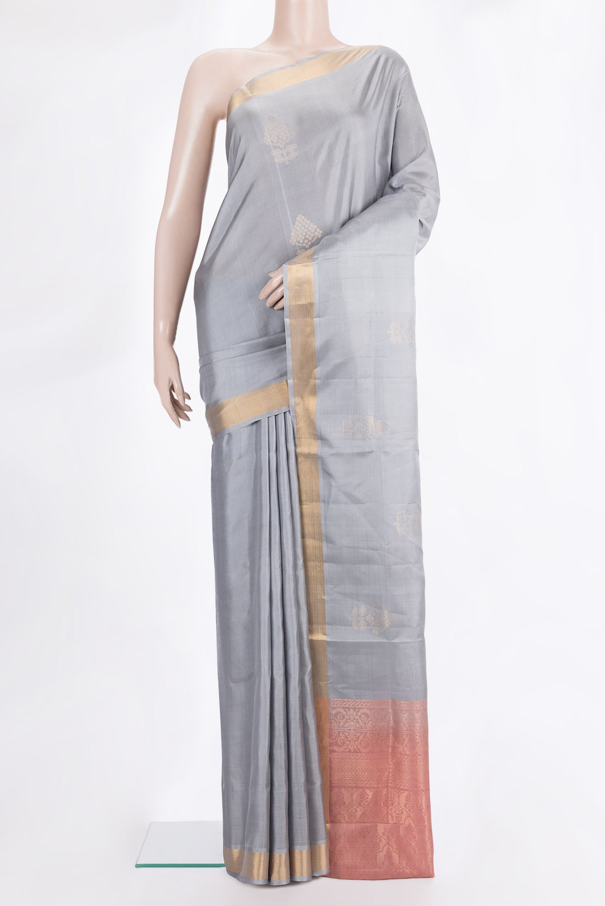 Pure Silk Grey Soft Saree with Zari Butta on the body and Zari Border.  displayed on a mannequin
