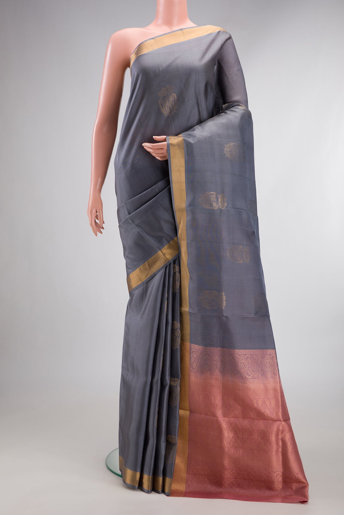 Pure Silk Grey Soft Saree with Zari Butta on the body and Zari Border.  displayed on a mannequin