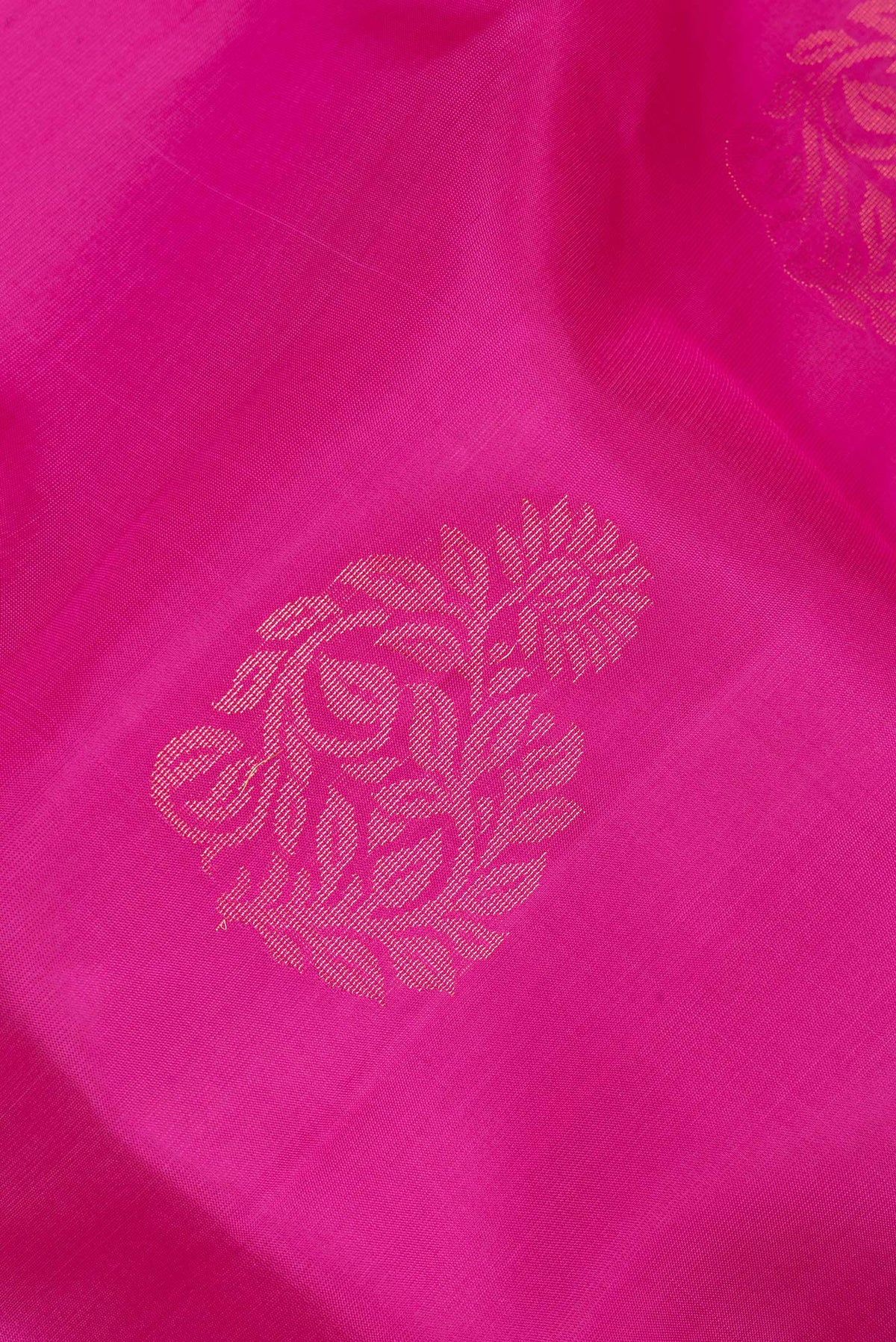 Close up of Pure Silk Dark Pink Soft Saree with Zari Butta on the body and Zari Border.  displaying folds