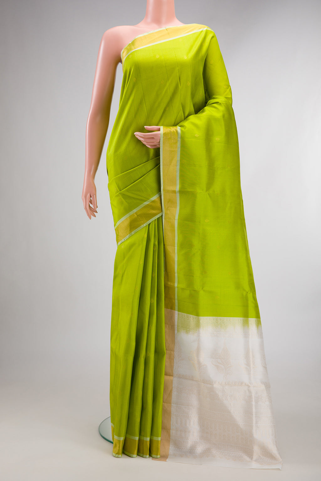 Pure Silk Parrot Green Soft Saree with Zari Butta on the body and Zari Border.  displayed on a mannequin