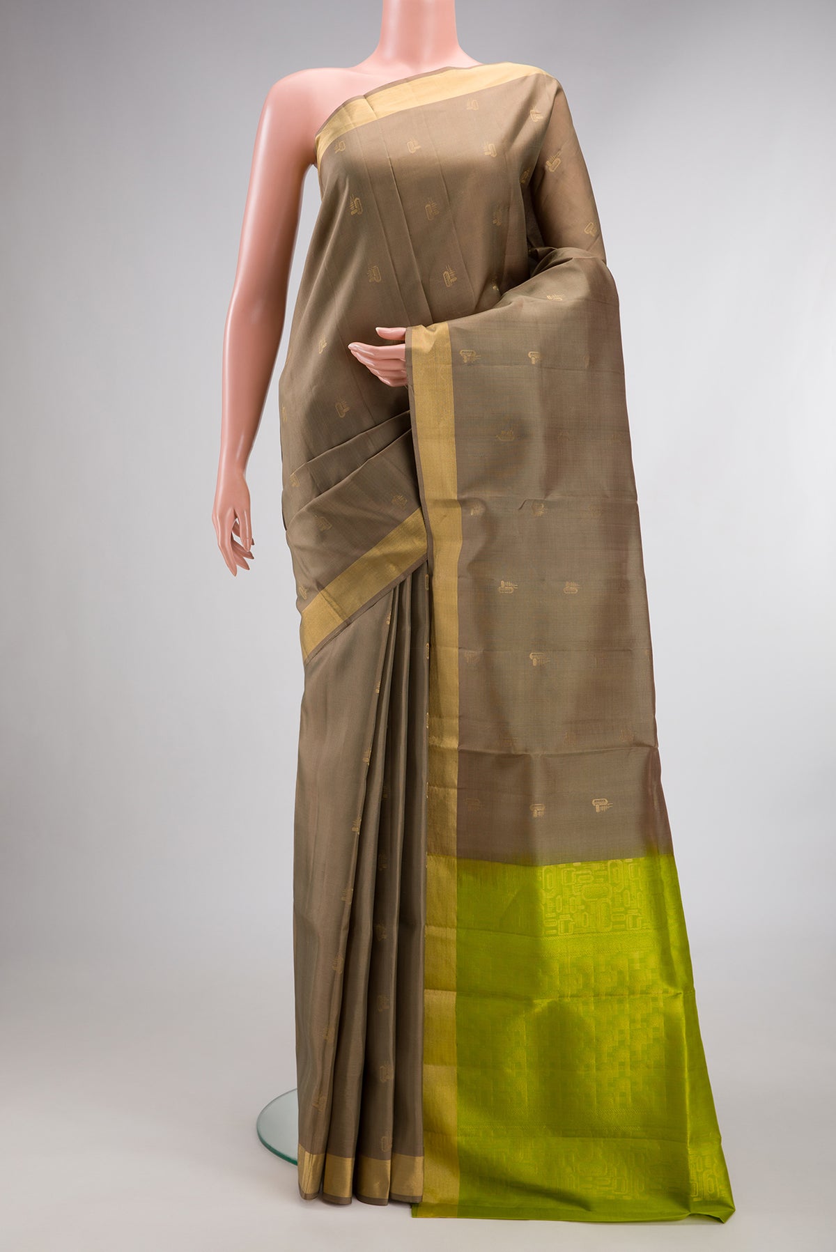 Pure Silk Dark Beige Soft Saree with Zari Butta on the body and Zari Border.  displayed on a mannequin