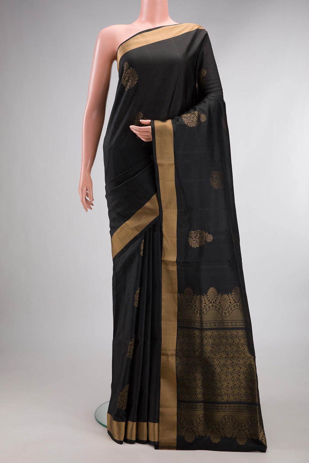 Pure Silk Black Soft Saree with Zari Butta on the body and Zari Border.  displayed on a mannequin