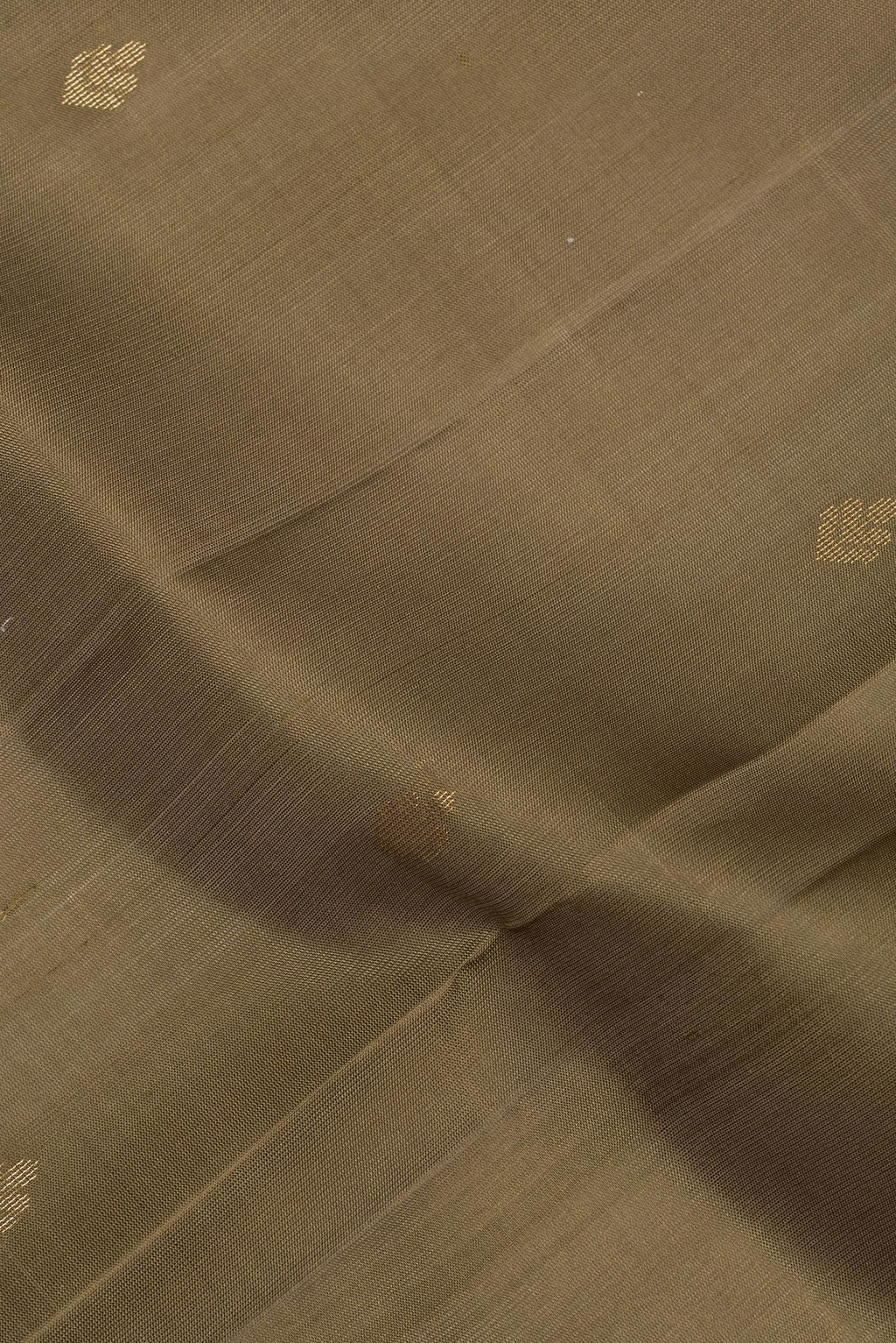 Close up of Pure Silk Brown Soft Saree with Zari Butta on the body and Zari Border.  displaying folds