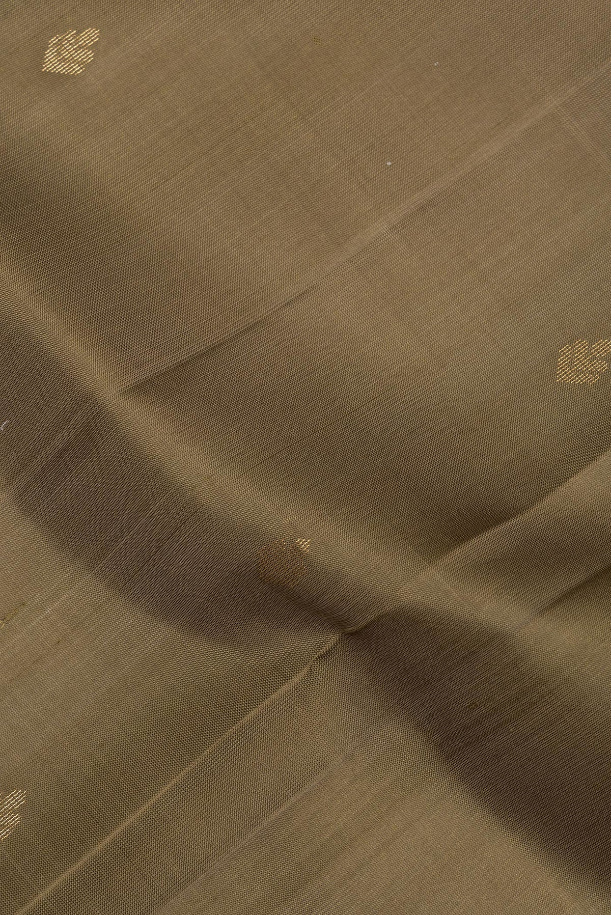 Close up of Pure Silk Brown Soft Saree with Zari Butta on the body and Zari Border.  displaying folds