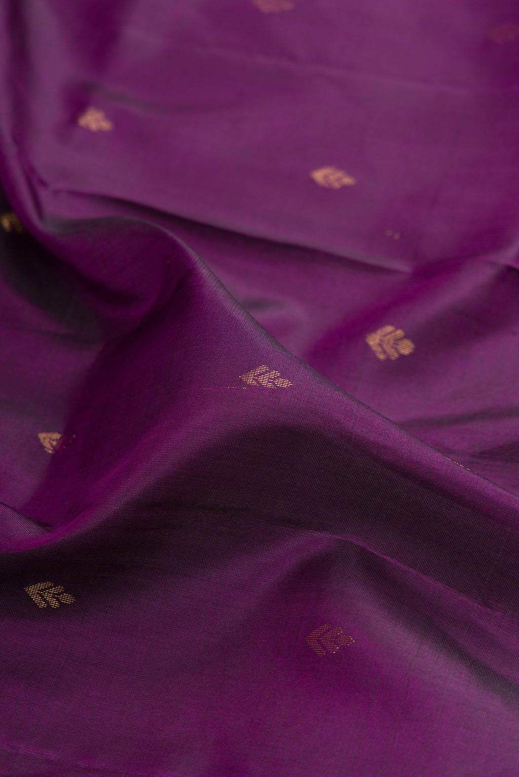 Close up of Pure Silk Purple Soft Saree with Zari Butta on the body and Zari Border.  displaying folds