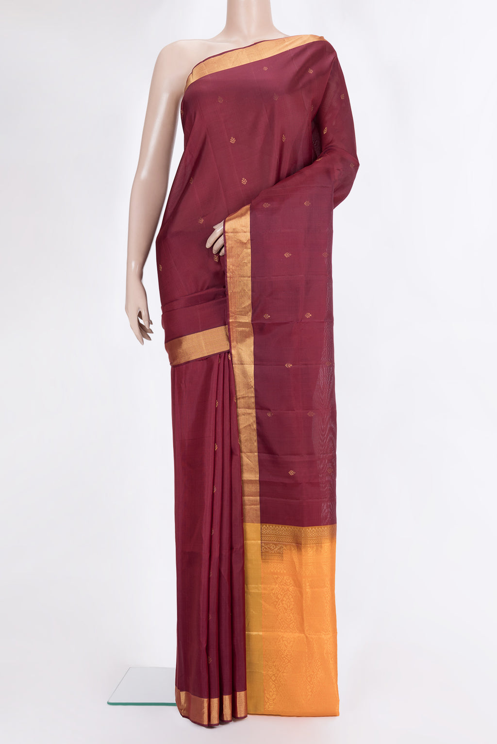 Pure Silk Maroon Soft Saree with Zari Butta on the body and Zari Border.  displayed on a mannequin