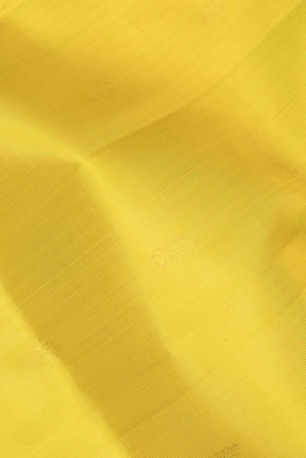 Close up of Pure Silk Lemon Yellow Soft Saree with Zari Butta on the body and Zari Border.  displaying folds