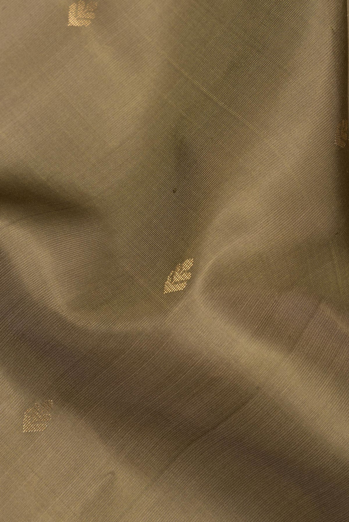Close up of Pure Silk Mehandi Green Soft Saree with Zari Butta on the body and Zari Border.  displaying folds