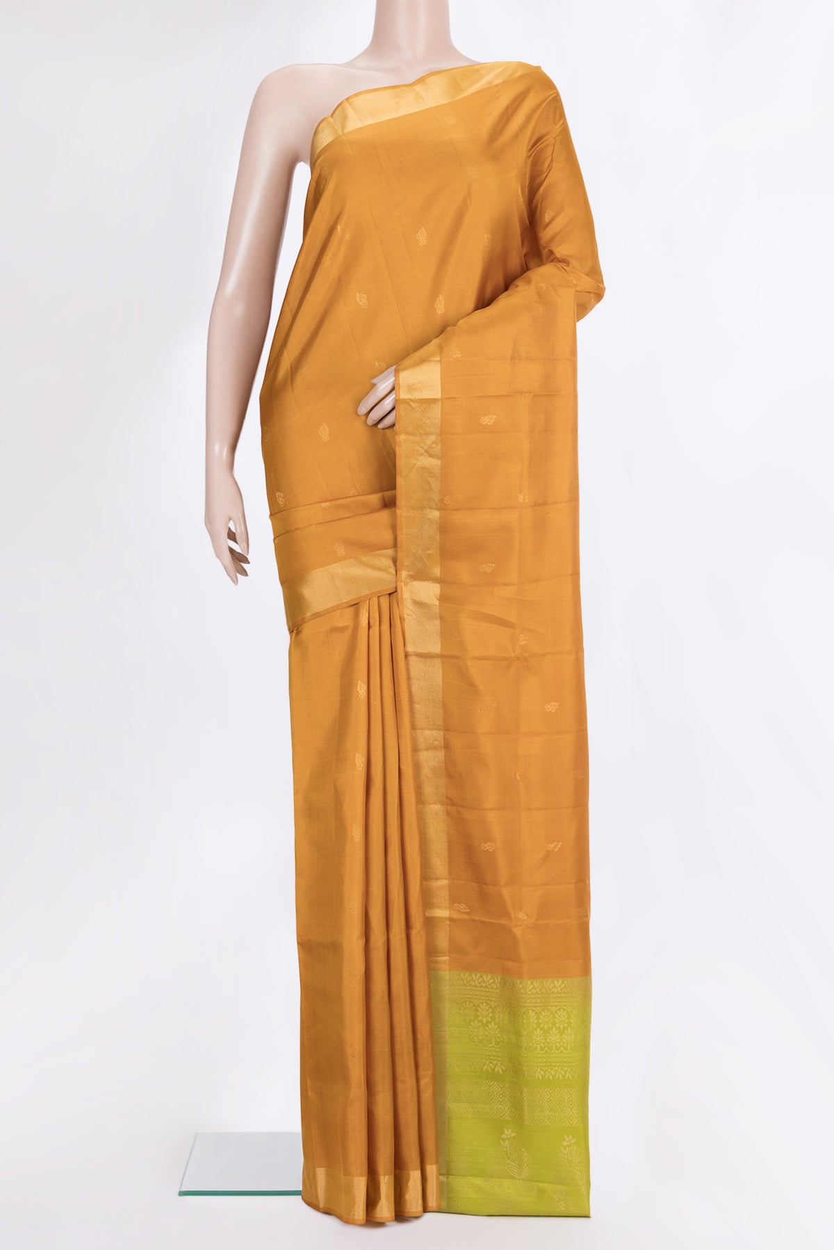 Pure Silk Mustard Soft Saree with Zari Butta on the body and Zari Border.  displayed on a mannequin
