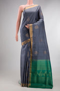 Pure Silk Grey Soft Saree with Zari Butta on the body and Zari Border.  displayed on a mannequin