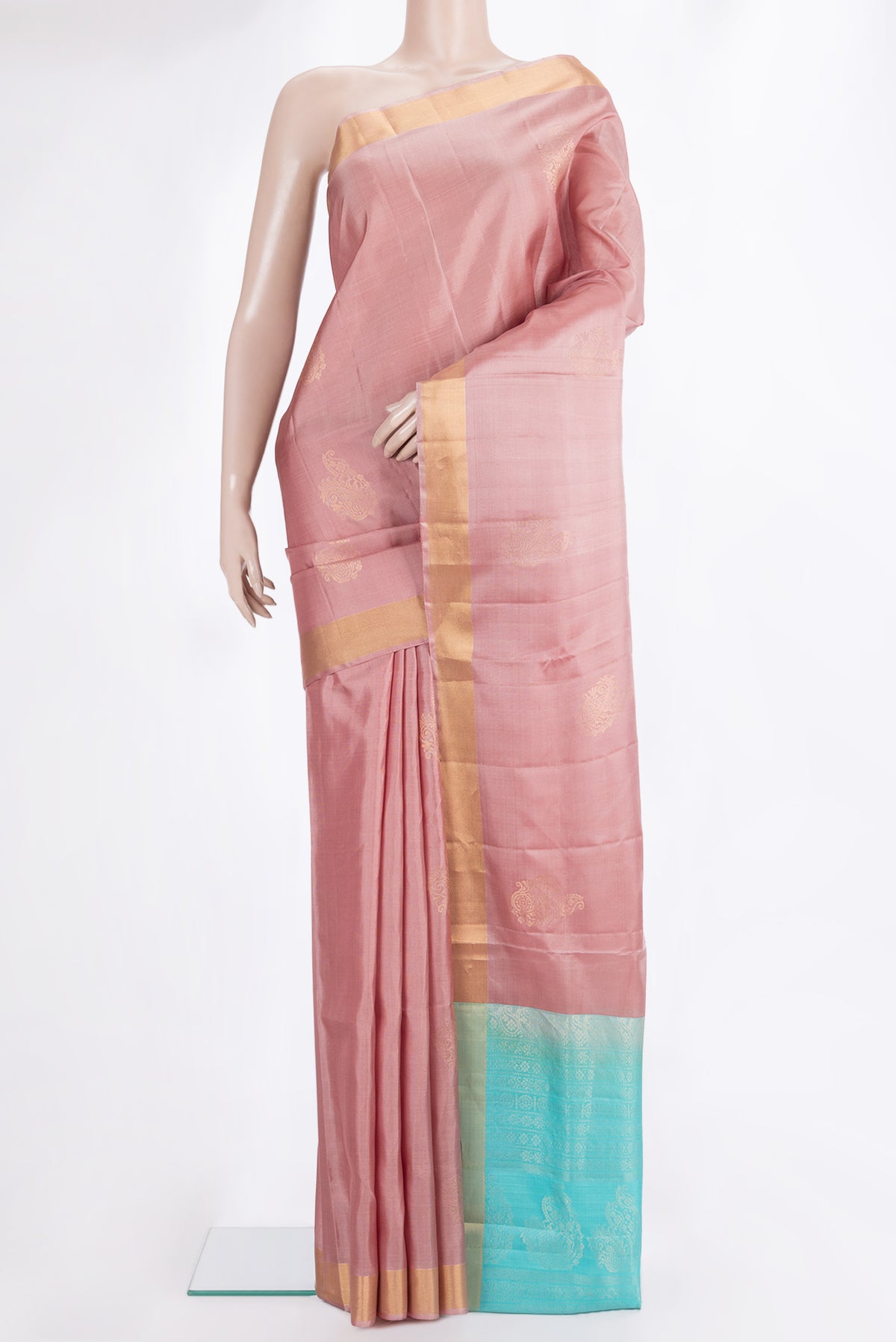 Pure Silk Rose Gold Soft Saree with Zari Butta on the body and Zari Border.  displayed on a mannequin