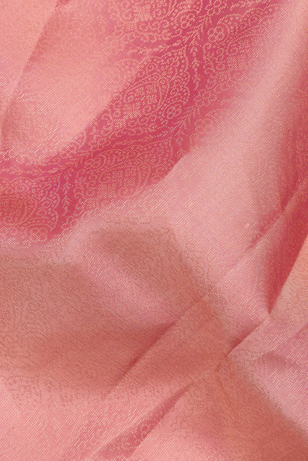 Close up of Pure Silk Coral Soft Saree with Zari Brocade on the body and Fancy Border.  displaying folds