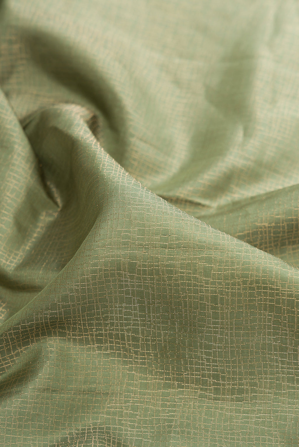Close up of Pure Silk Olive Green Soft Saree with Zari Brocade on the body and Fancy Border.  displaying folds