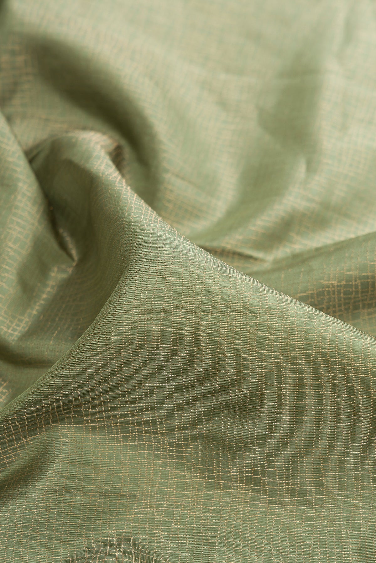 Close up of Pure Silk Olive Green Soft Saree with Zari Brocade on the body and Fancy Border.  displaying folds