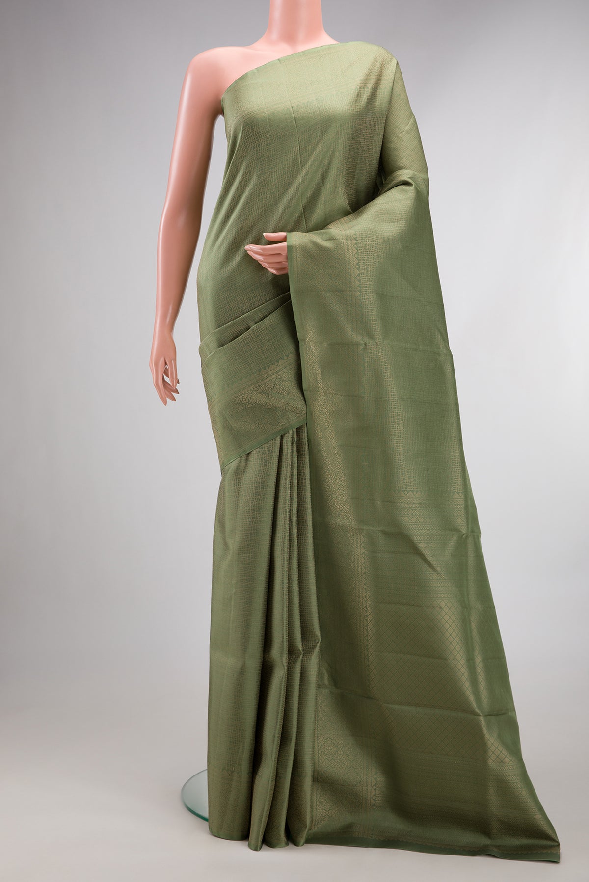 Pure Silk Olive Green Soft Saree with Zari Brocade on the body and Fancy Border.  displayed on a mannequin
