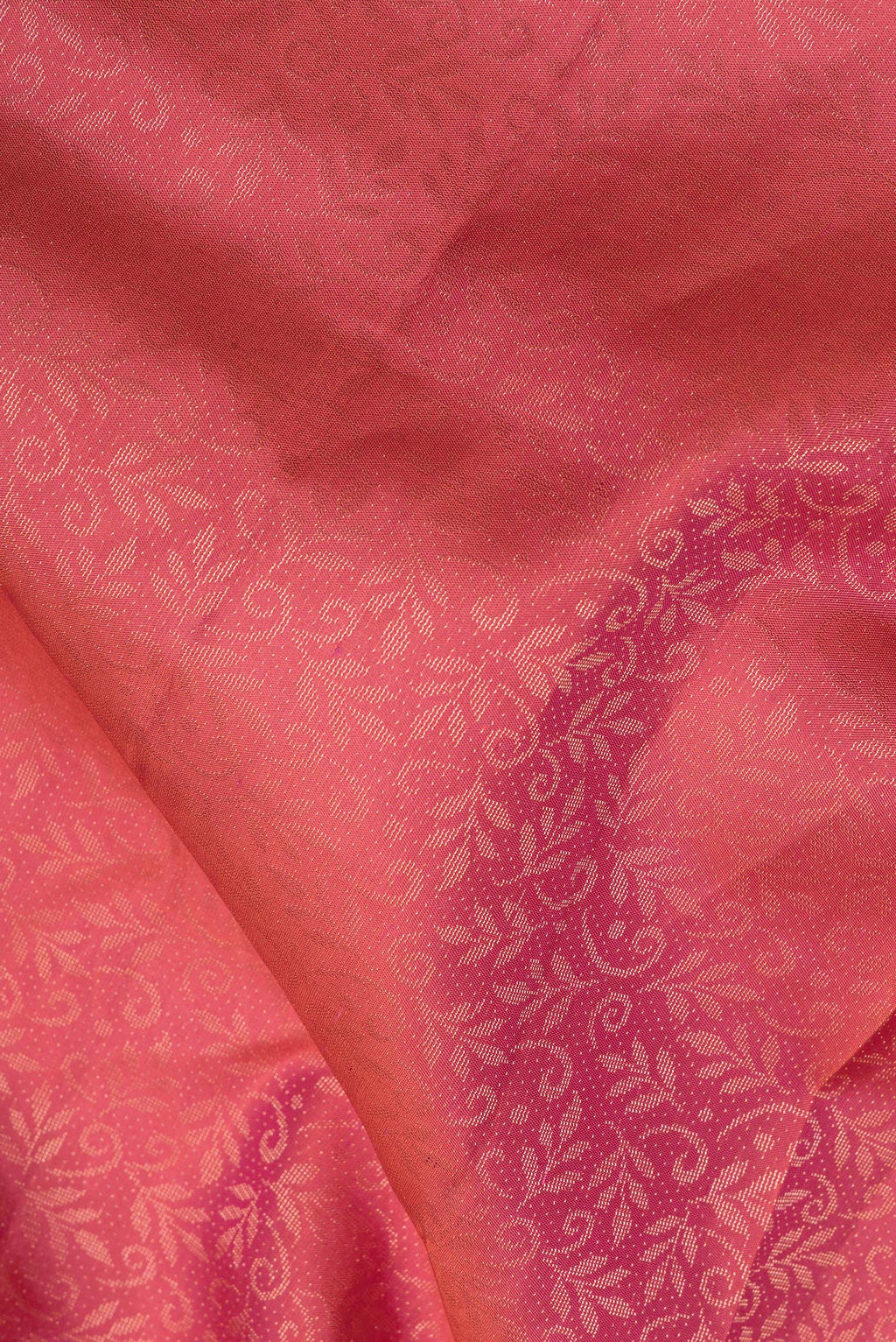 Close up of Pure Silk Coral Soft Saree with Zari Brocade on the body and Fancy Border.  displaying folds