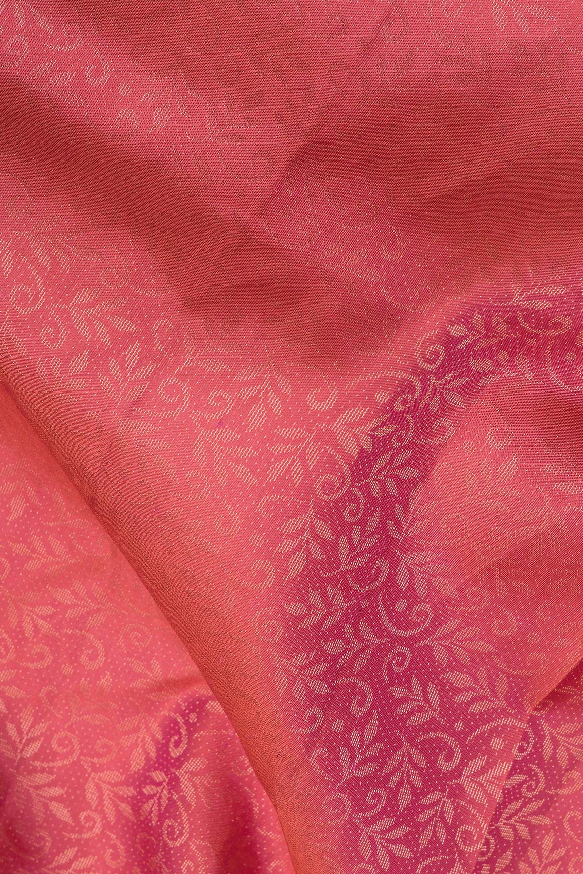 Close up of Pure Silk Coral Soft Saree with Zari Brocade on the body and Fancy Border.  displaying folds