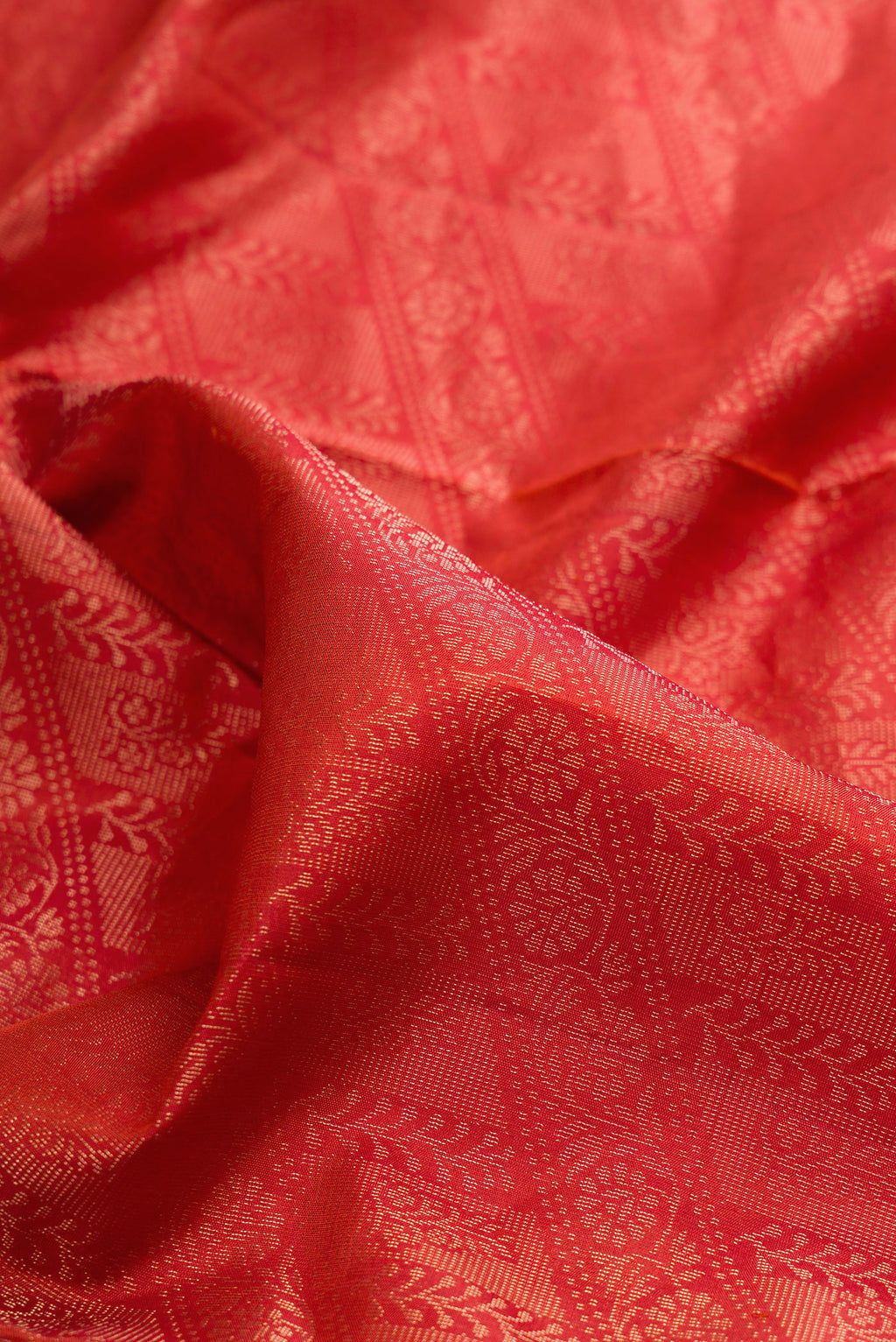 Close up of Pure Silk Orange Soft Saree with Zari Brocade on the body and Fancy Border.  displaying folds