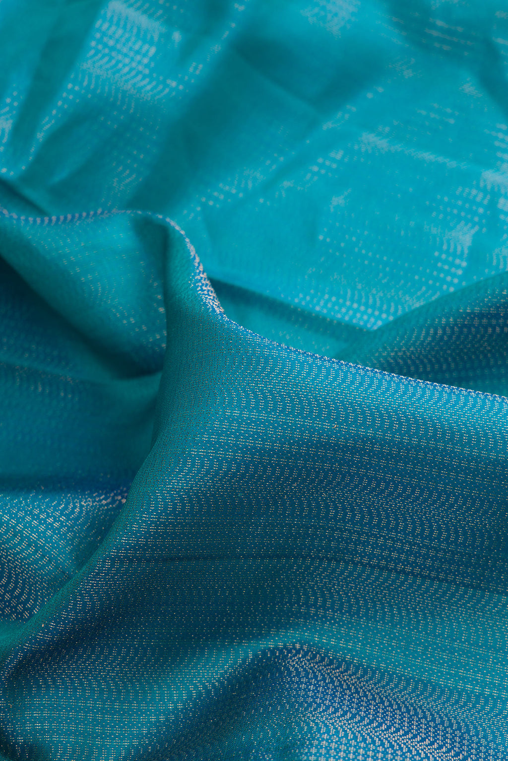 Close up of Pure Silk Peacock Blue Soft Saree with Zari Brocade on the body and Fancy Border.  displaying folds