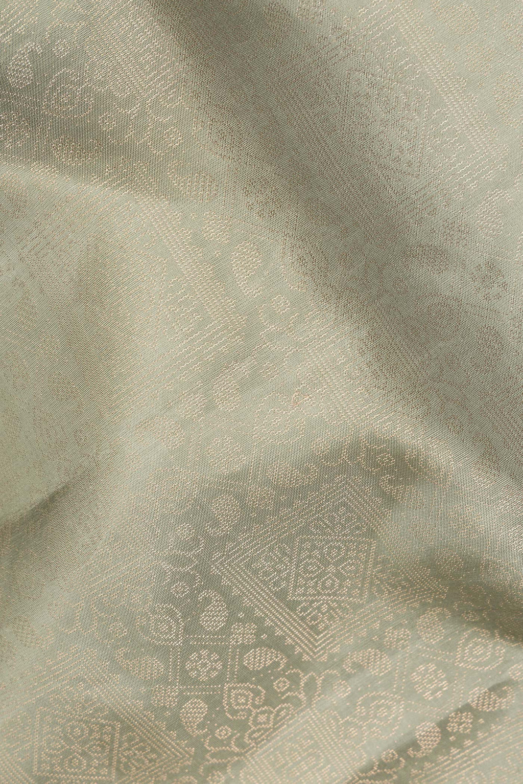 Close up of Pure Silk Sage Green Soft Saree with Zari Brocade on the body and Fancy Border.  displaying folds