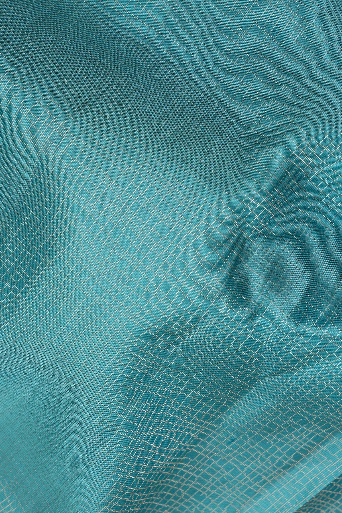 Close up of Pure Silk Sky Blue Soft Saree with Zari Brocade on the body and Fancy Border.  displaying folds