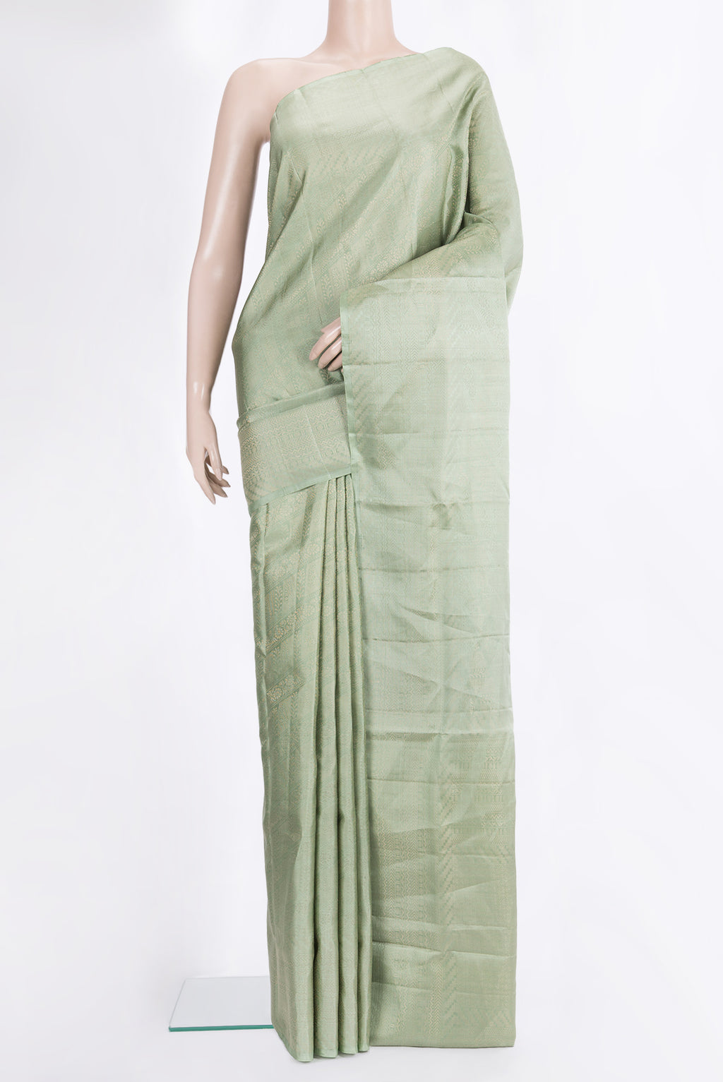 Pure Silk Pista Green Soft Saree with Zari Brocade on the body and Fancy Border.  displayed on a mannequin