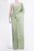 Pure Silk Pista Green Soft Saree with Zari Brocade on the body and Fancy Border.  displayed on a mannequin
