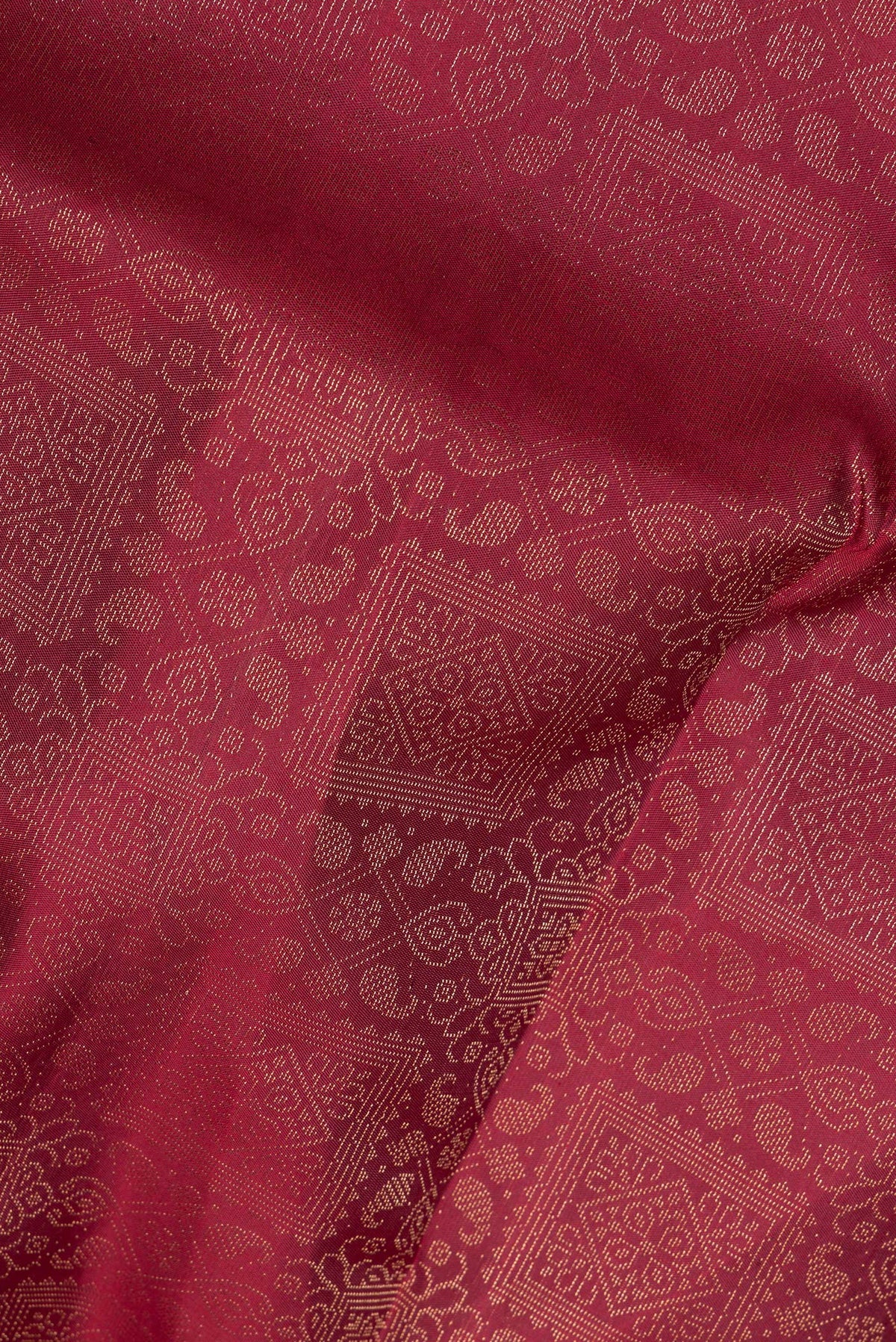 Close up of Pure Silk Maroon Soft Saree with Zari Brocade on the body and Fancy Border.  displaying folds
