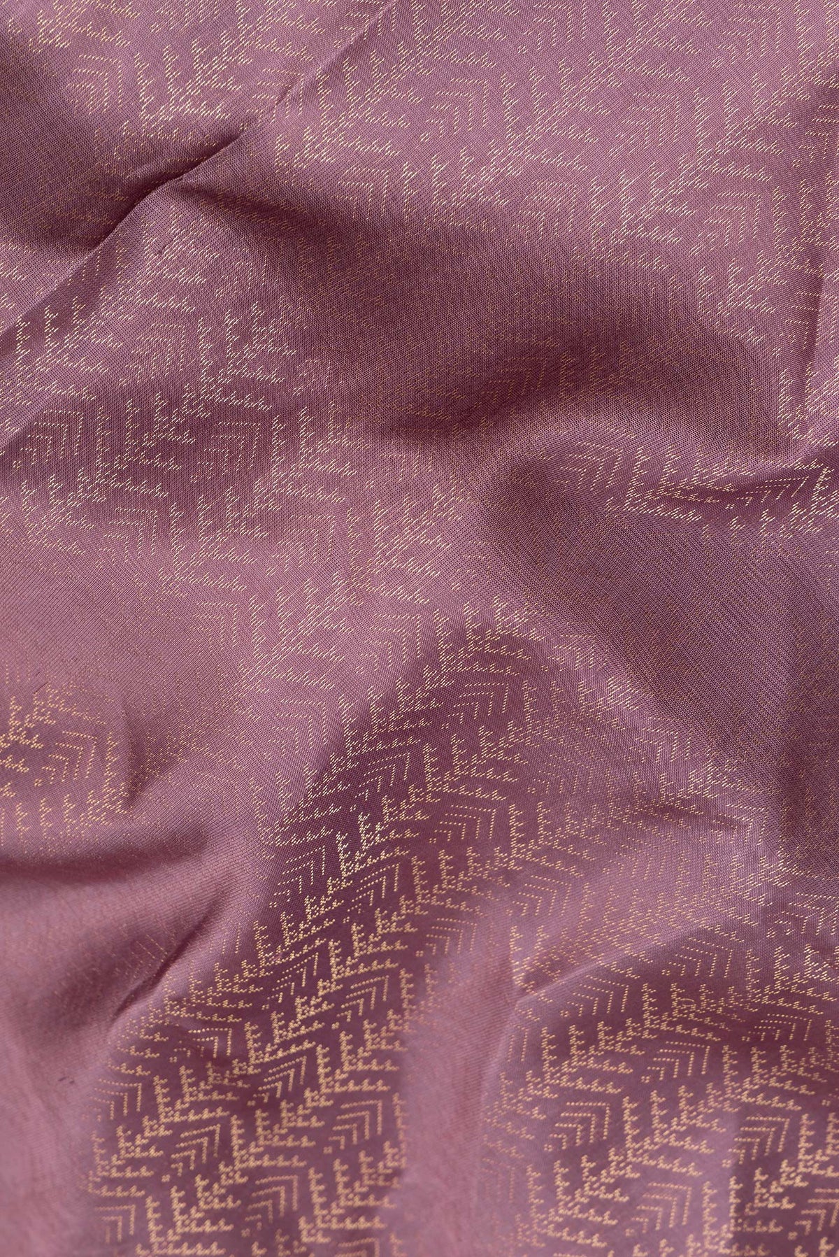 Close up of Pure Silk Mauve Soft Saree with Zari Brocade on the body and Fancy Border.  displaying folds