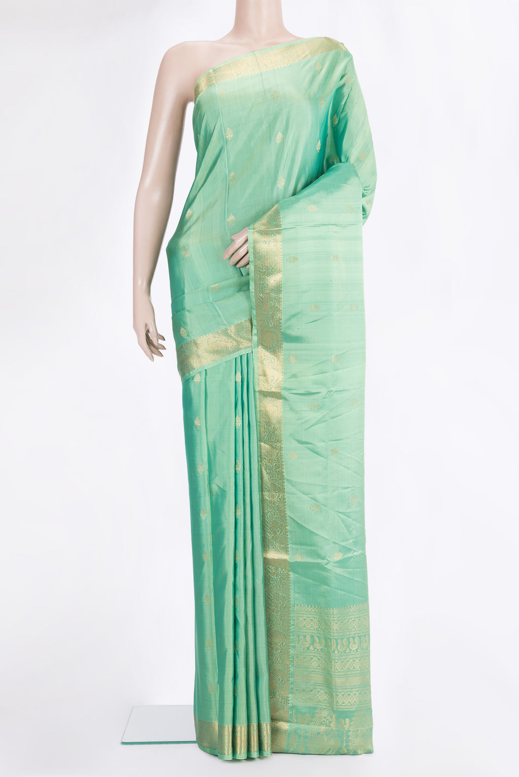 Pure Silk Green Soft Saree with Zari Butta on the body and Zari Border.  displayed on a mannequin
