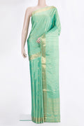 Pure Silk Green Soft Saree with Zari Butta on the body and Zari Border.  displayed on a mannequin