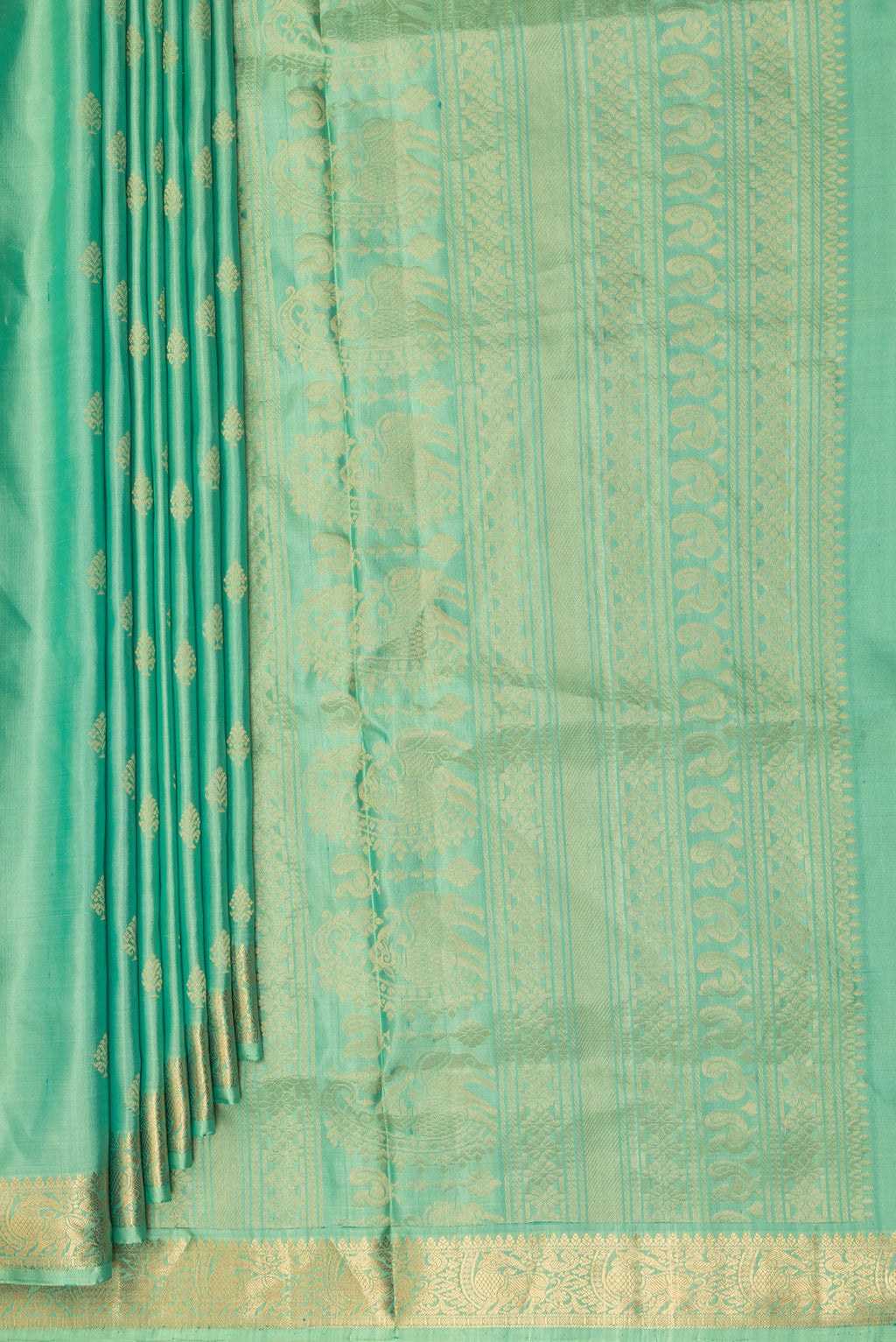 Pleats and pallu of Pure Silk Green Soft Saree with Zari Butta on the body and Zari Border. 