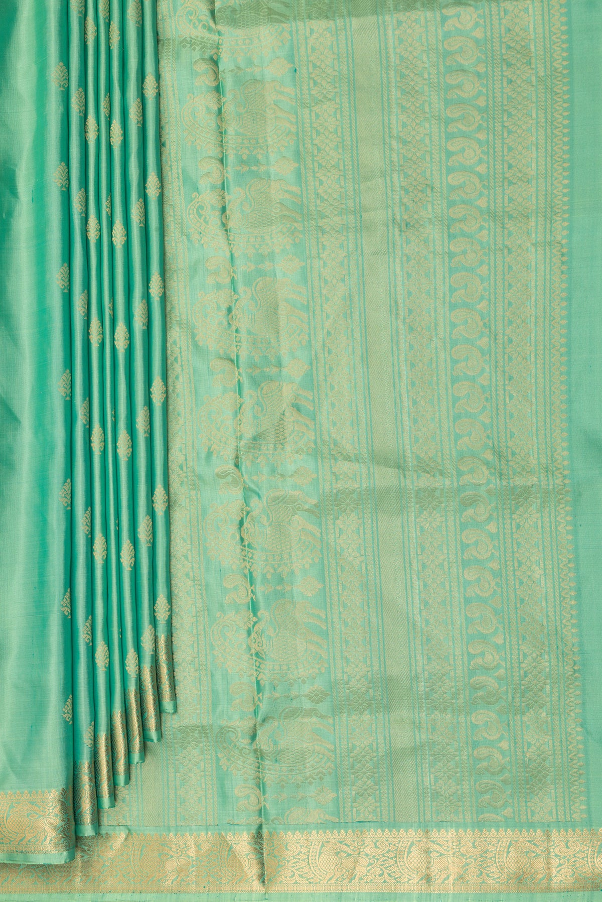 Pleats and pallu of Pure Silk Green Soft Saree with Zari Butta on the body and Zari Border. 