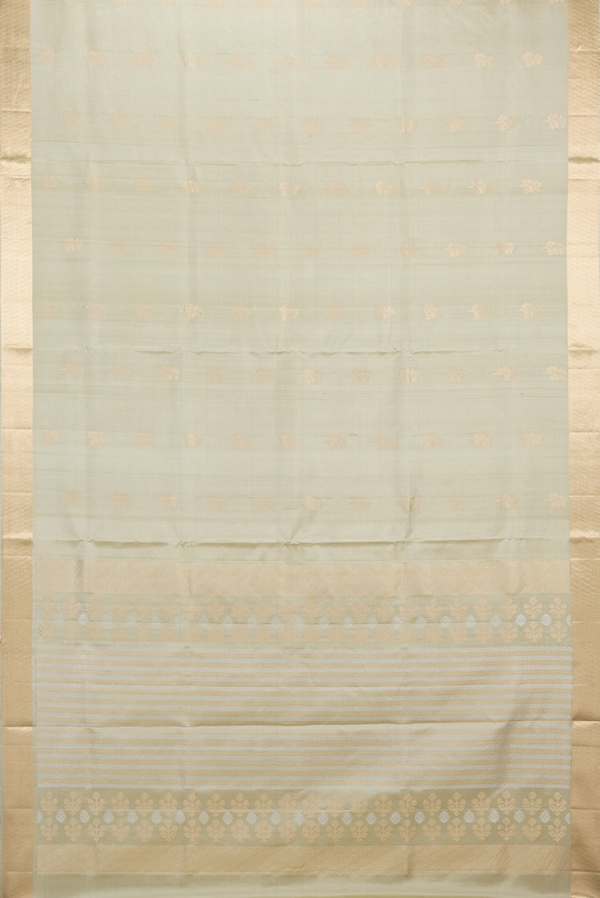 Flat view of Pure Silk Beige Soft Saree with Zari Butta on the body and Zari Border. 