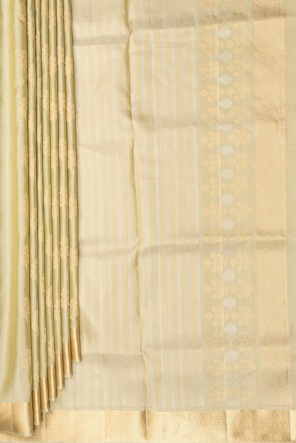 Pleats and pallu of Pure Silk Beige Soft Saree with Zari Butta on the body and Zari Border. 