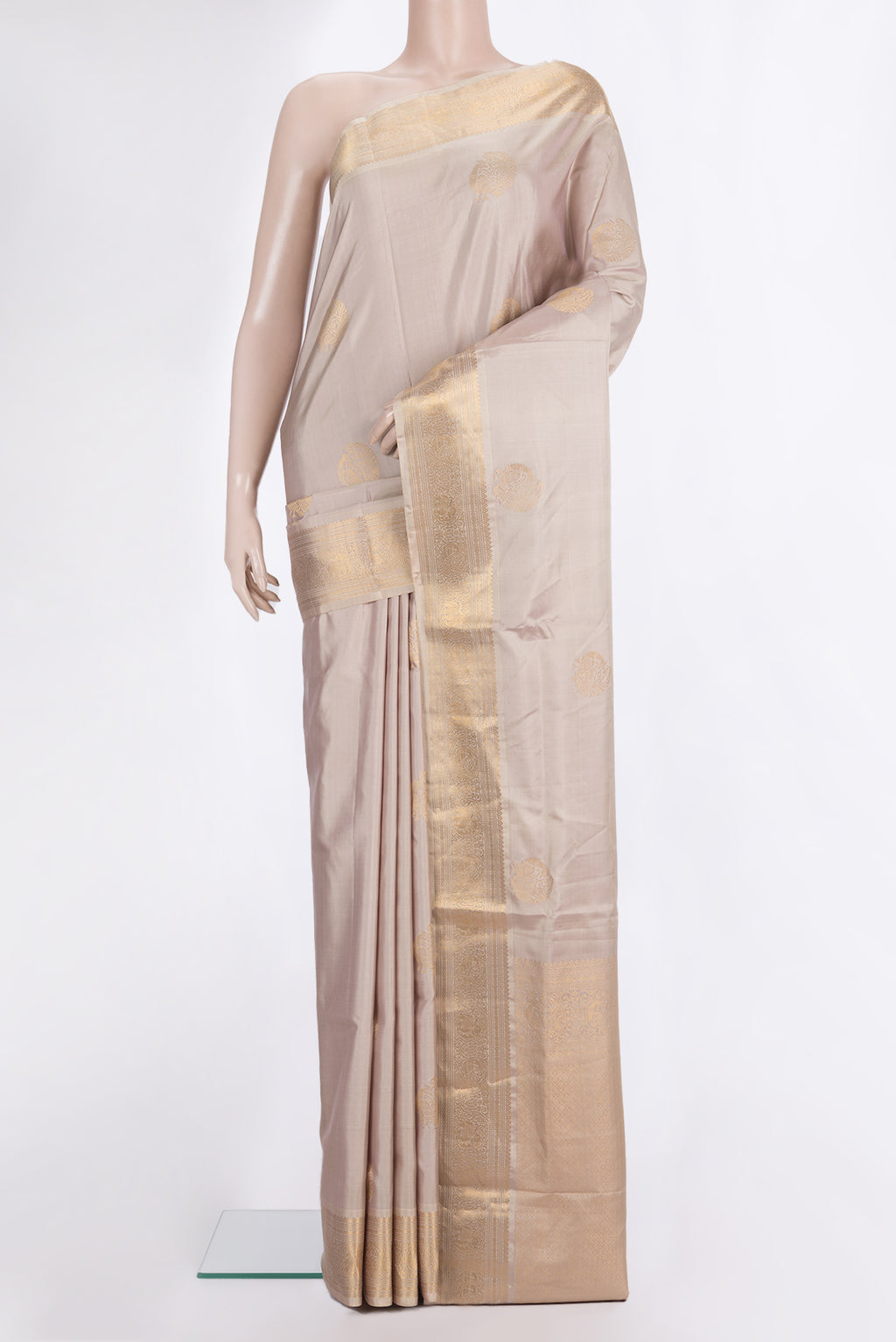 Pure Silk Rose Gold Soft Saree with Zari Butta on the body and Zari Border.  displayed on a mannequin