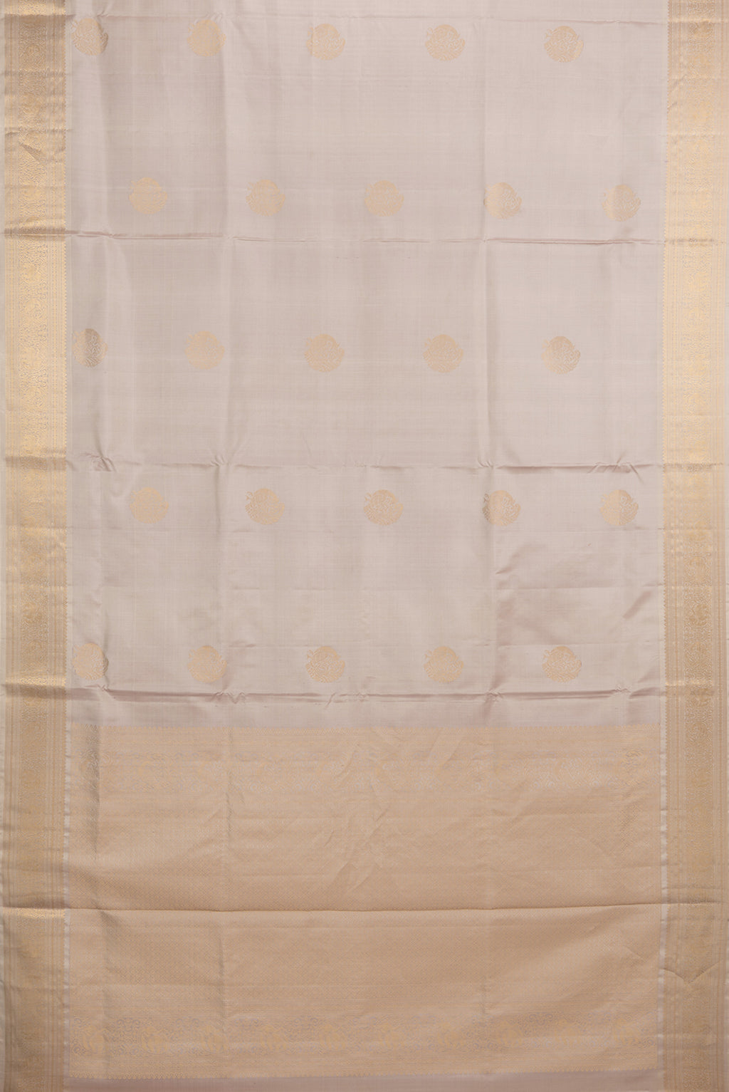 Flat view of Pure Silk Rose Gold Soft Saree with Zari Butta on the body and Zari Border. 