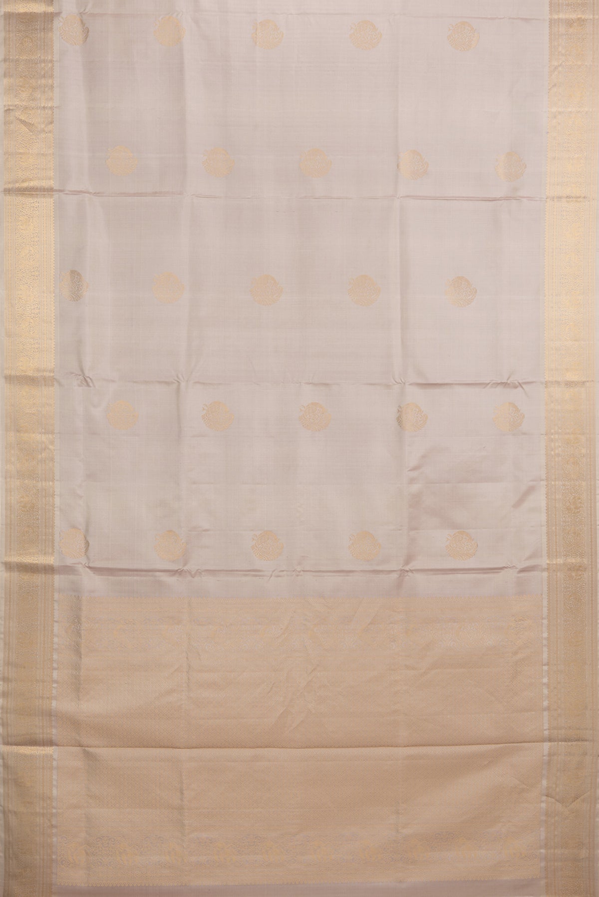 Flat view of Pure Silk Rose Gold Soft Saree with Zari Butta on the body and Zari Border. 