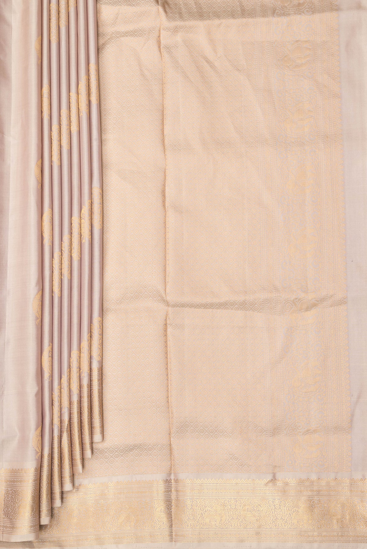 Pleats and pallu of Pure Silk Rose Gold Soft Saree with Zari Butta on the body and Zari Border. 