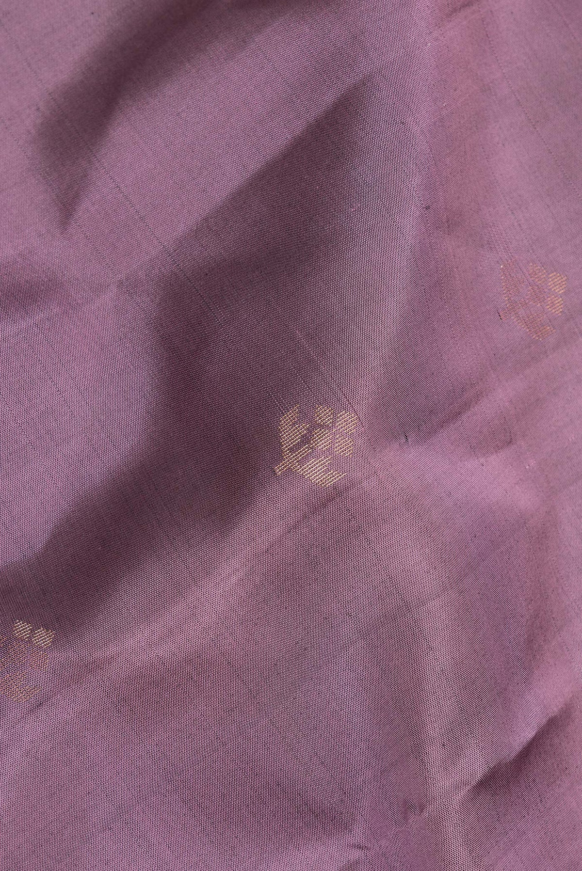 Close up of Pure Silk Mauve Soft Saree with Zari Butta on the body and Zari Border.  displaying folds