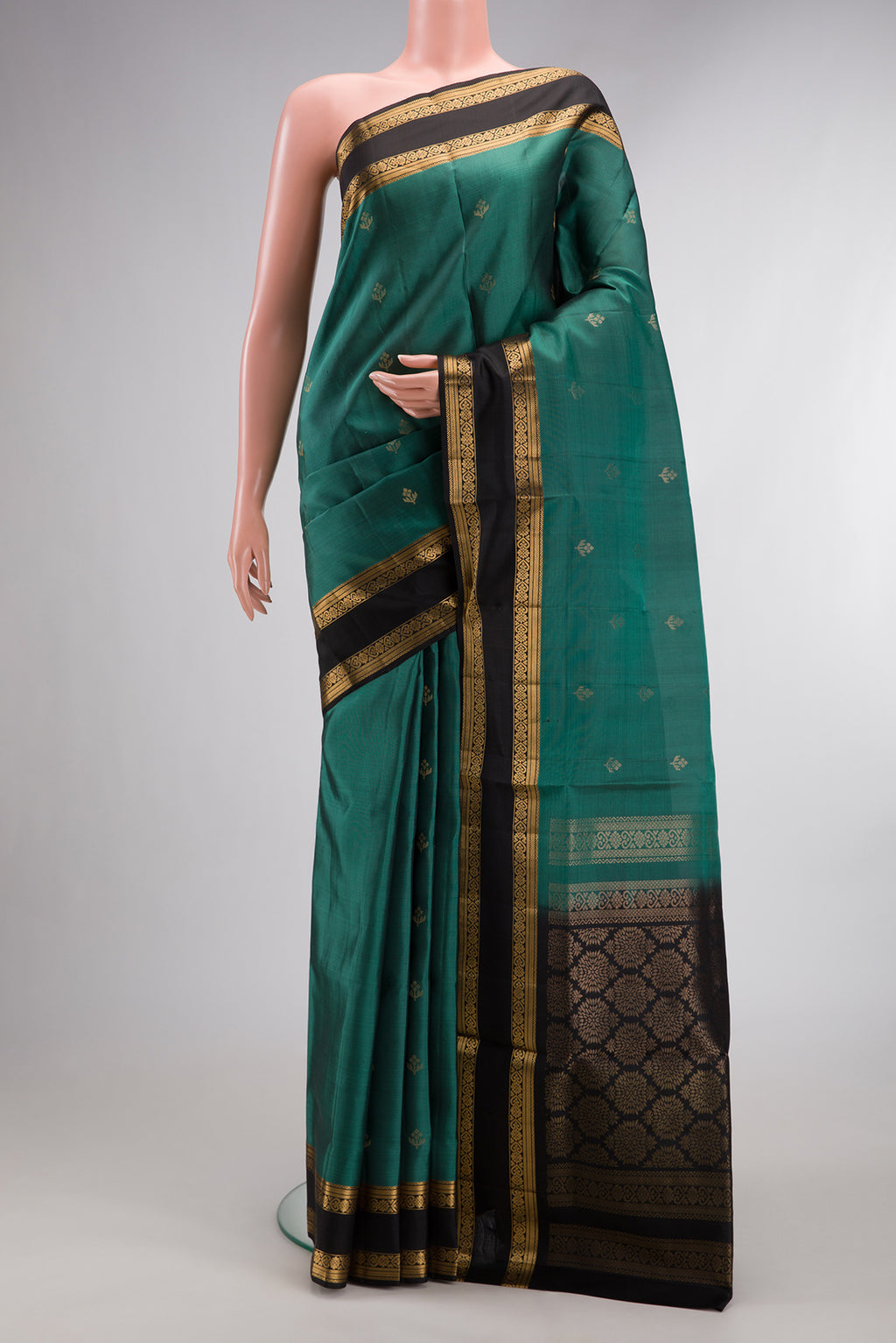 Pure Silk Green Soft Saree with Zari Butta on the body and Zari Border.  displayed on a mannequin