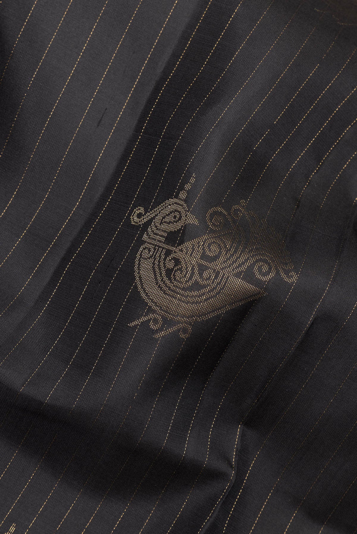 Close up of Pure Silk Black Soft Saree with Zari Butta on the body and Without Border.  displaying folds