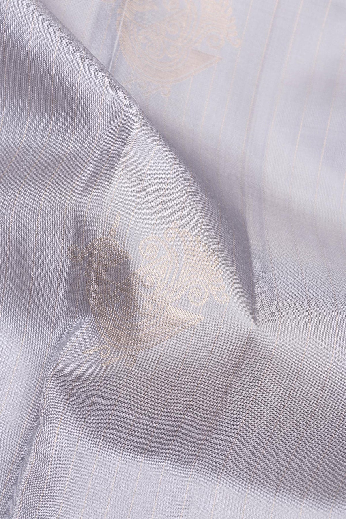 Close up of Pure Silk Grey Soft Saree with Zari Butta on the body and Without Border.  displaying folds